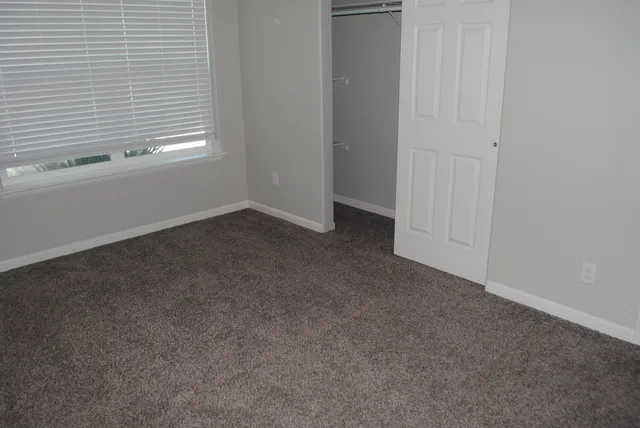 a view of a livingroom with an empty space and a window
