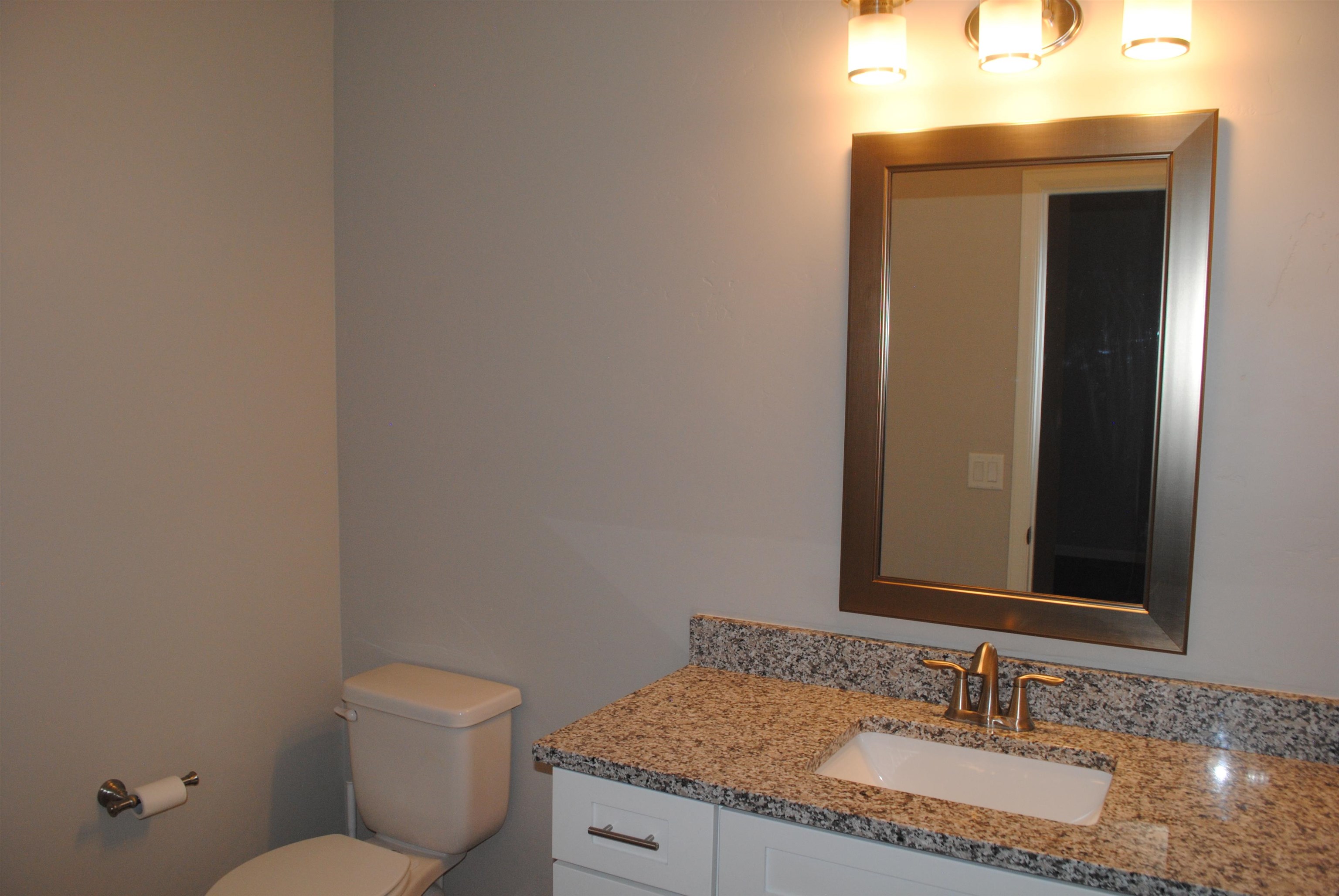 454 Lewis Street Grand Junction, CO 81504 - Photo 3 of 20 a bathroom with a granite countertop sink and a mirror