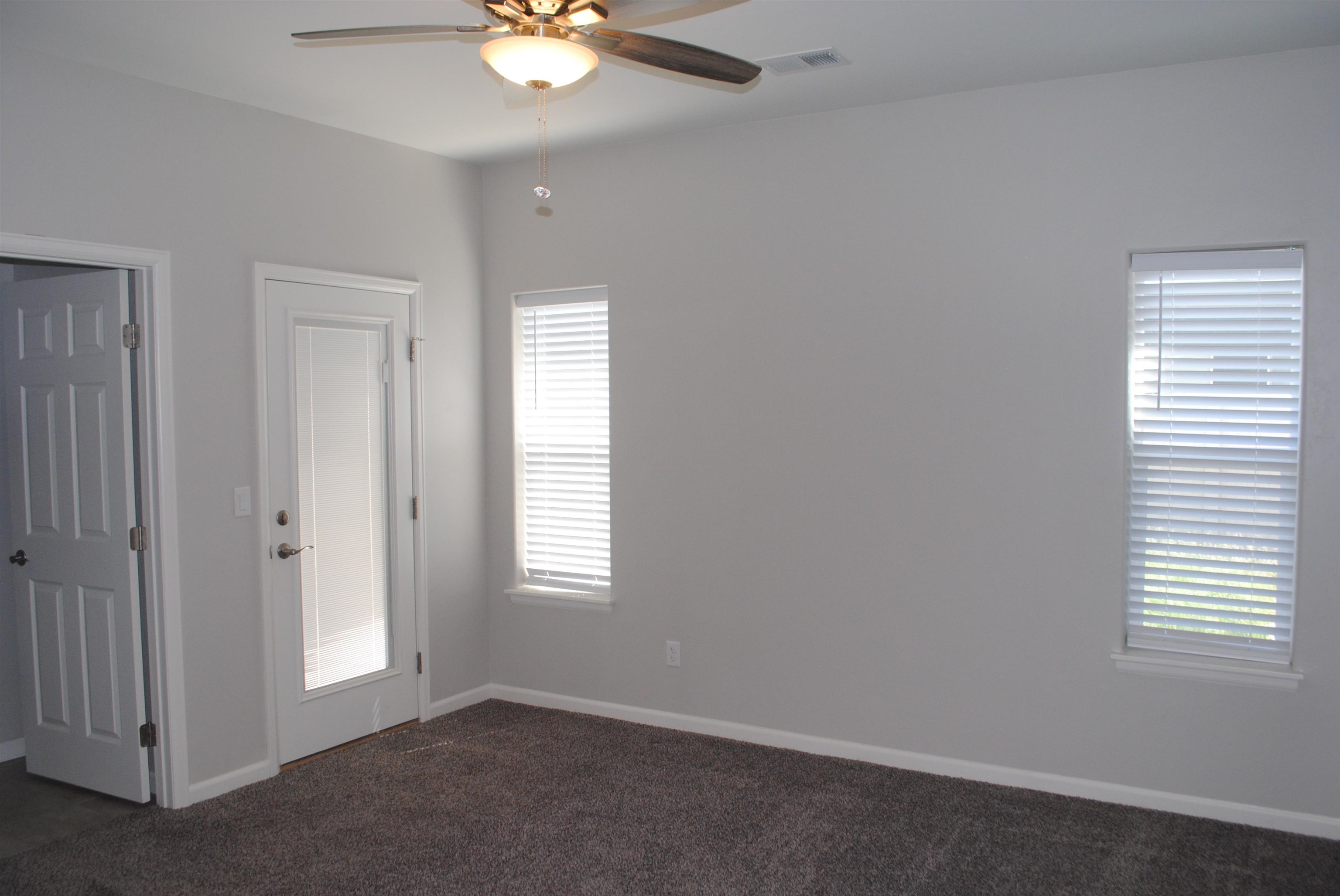 454 Lewis Street Grand Junction, CO 81504 - Photo 4 of 20 an empty room with windows and fan