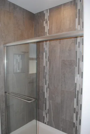 a bathroom with a glass shower door