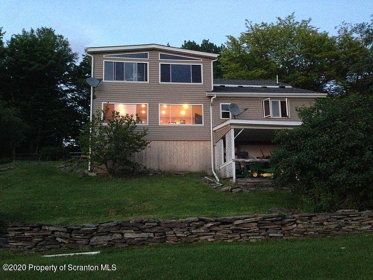6197 Spring Hill Road Wyalusing, PA 18853 - Photo 2 of 15 a front view of a house with a yard