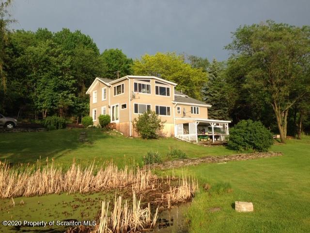 6197 Spring Hill Road Wyalusing, PA 18853 - Photo 3 of 15 a front view of a house with a yard