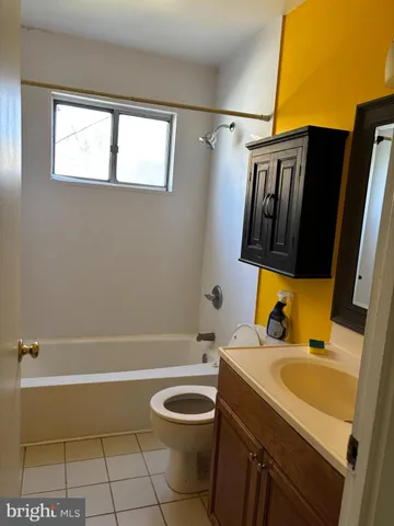 a bathroom with a sink a toilet and bathtub