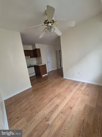 wooden floor in an empty room with a chandelier