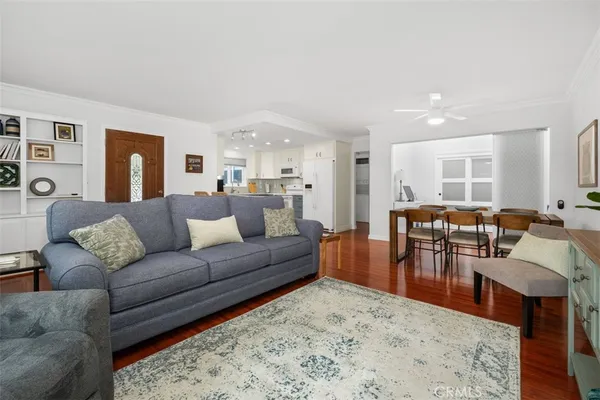 a living room with furniture wooden floor and a table