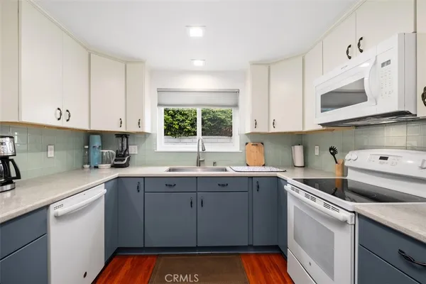 a kitchen with a sink cabinets and window