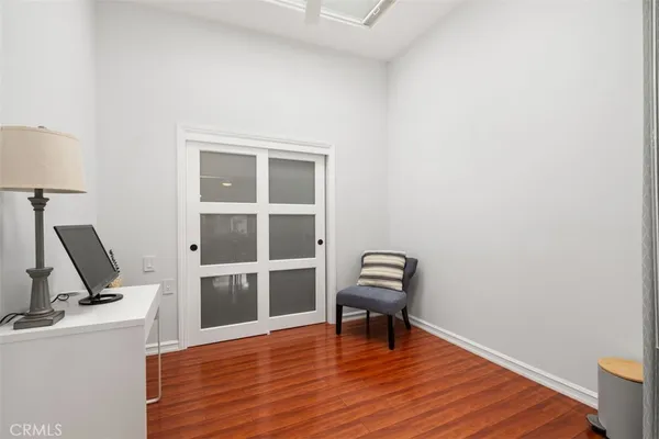 a view of a workspace with wooden floor