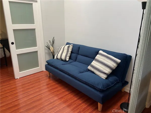 a living room with furniture and a wooden floor