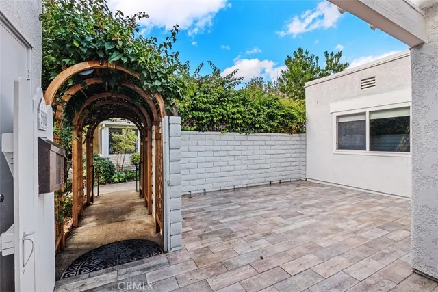 a view of a door of the house with a yard