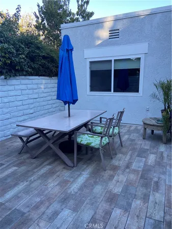 a backyard of a house with table and chairs