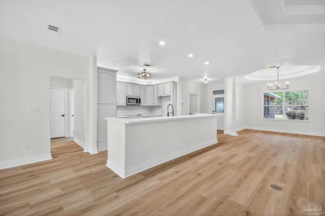 a kitchen with stainless steel appliances a stove sink and cabinets