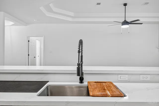a view of empty room with wooden floor fan and window
