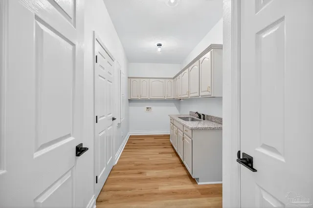 a spacious bathroom with a granite countertop sink a mirror and shower