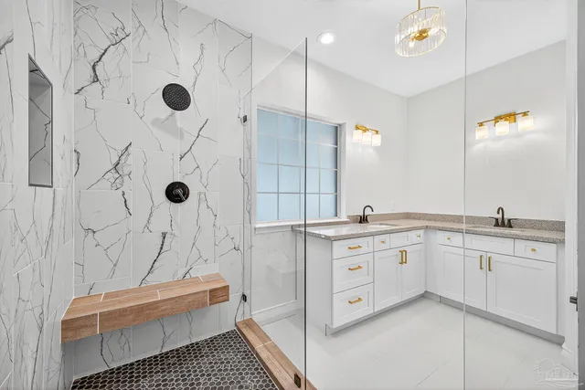 a bathroom with a granite countertop sink mirror and double