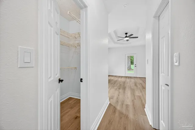 an empty room with windows and closet