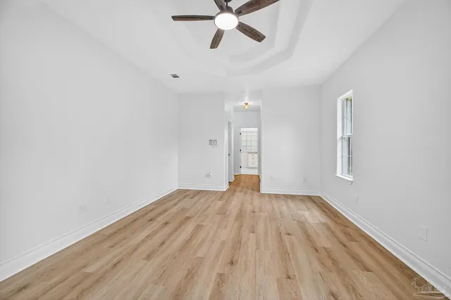 a view of a room with wooden floor