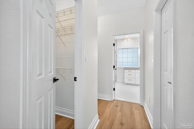 a view of a room with wooden floor and a ceiling fan