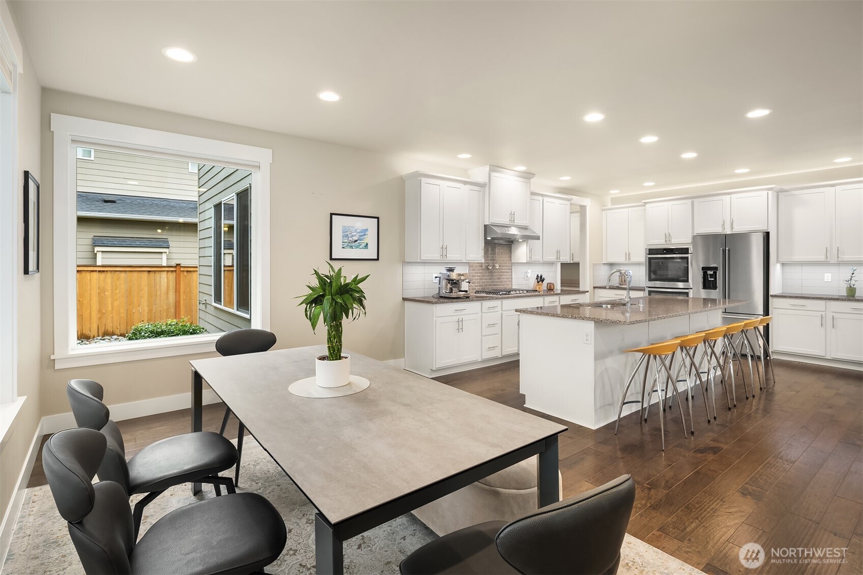 1435 242nd Place Southeast Bothell, WA 98021 - Photo 16 of 40 a kitchen with kitchen island a dining table and chairs