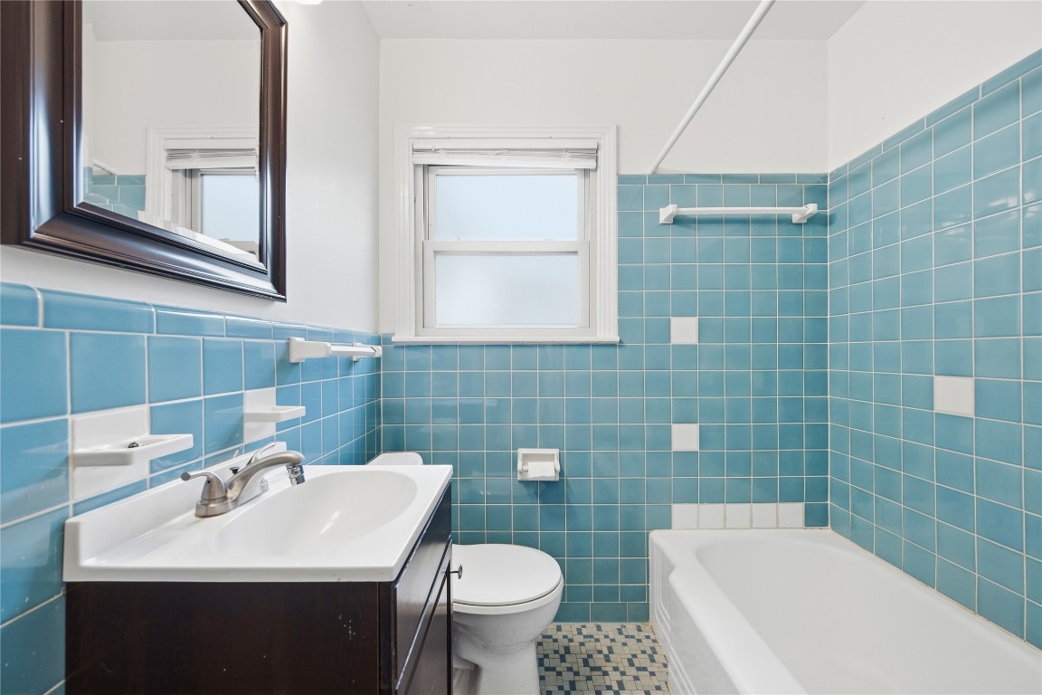 1003 Cogbill Street, Unit 1 Austin, TX 78745 - Photo 11 of 15 a bathroom with a sink a toilet and a mirror