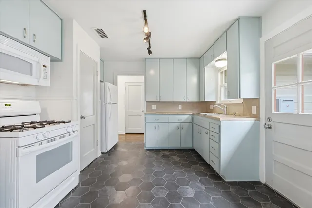 a view of a kitchen with a stove cabinets and wooden floor