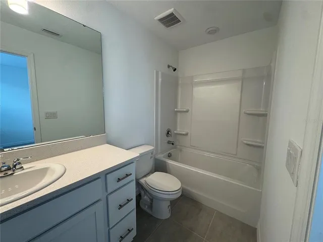 a bathroom with a sink toilet and a mirror