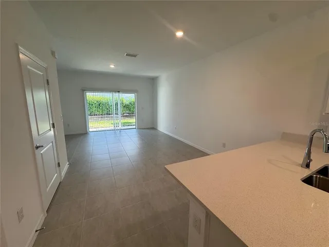 a view of a room with window and wooden floor