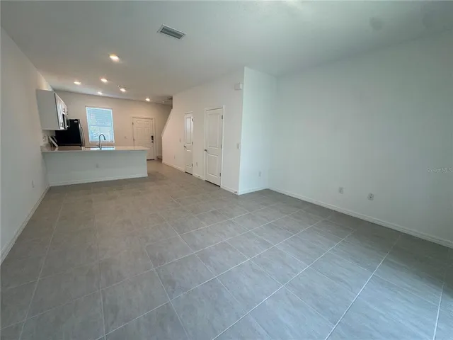 a kitchen with stainless steel appliances a refrigerator sink microwave and cabinets