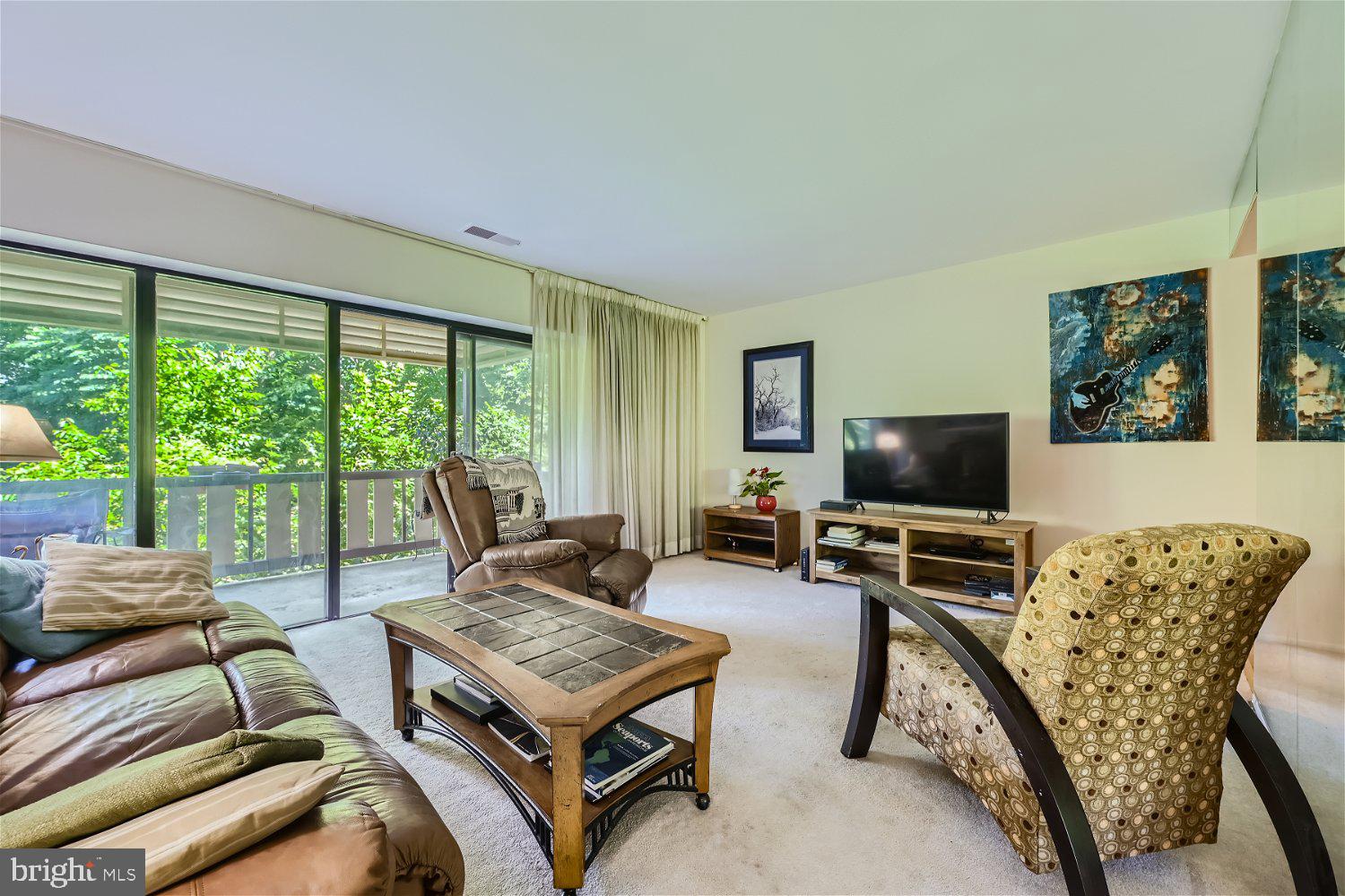 200 Cross Keys Road, Unit R39 Baltimore, MD 21210 - Photo 8 of 26 living room with doors to balcony
