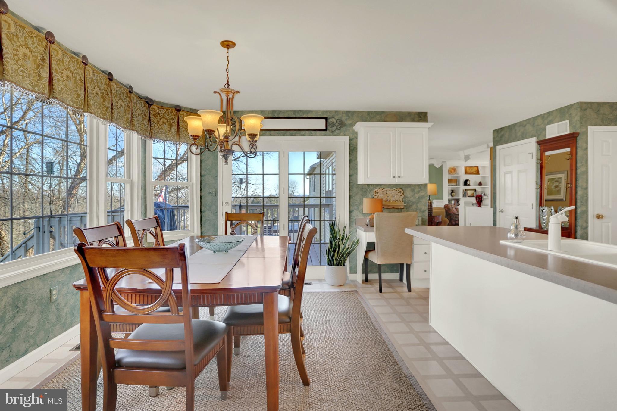 402 Hidden Valley Road New Cumberland, PA 17070 - Photo 14 of 50 a view of a dining room with furniture large windows and wooden floor
