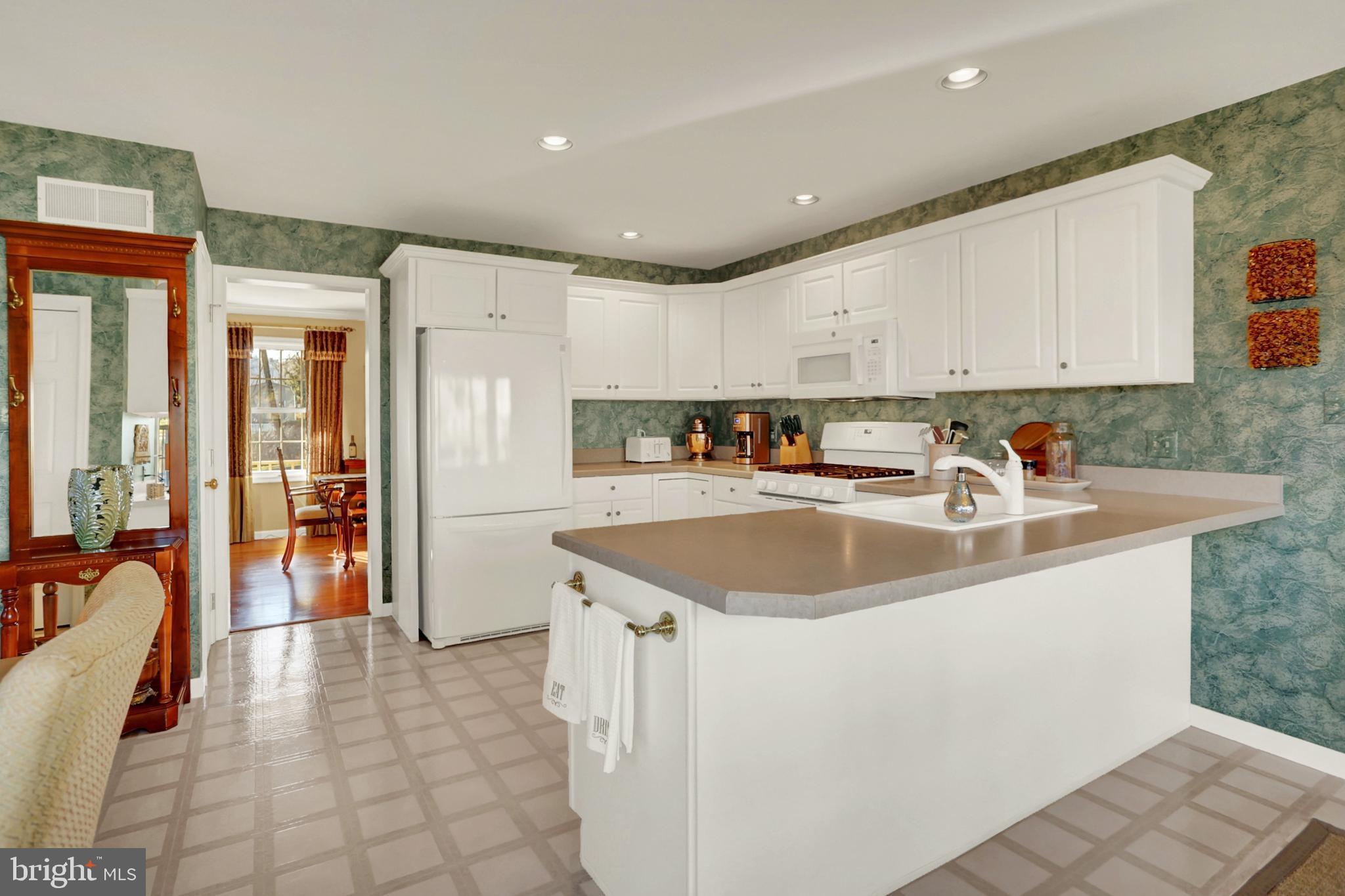 402 Hidden Valley Road New Cumberland, PA 17070 - Photo 16 of 50 a kitchen with stainless steel appliances granite countertop a sink a stove and a refrigerator