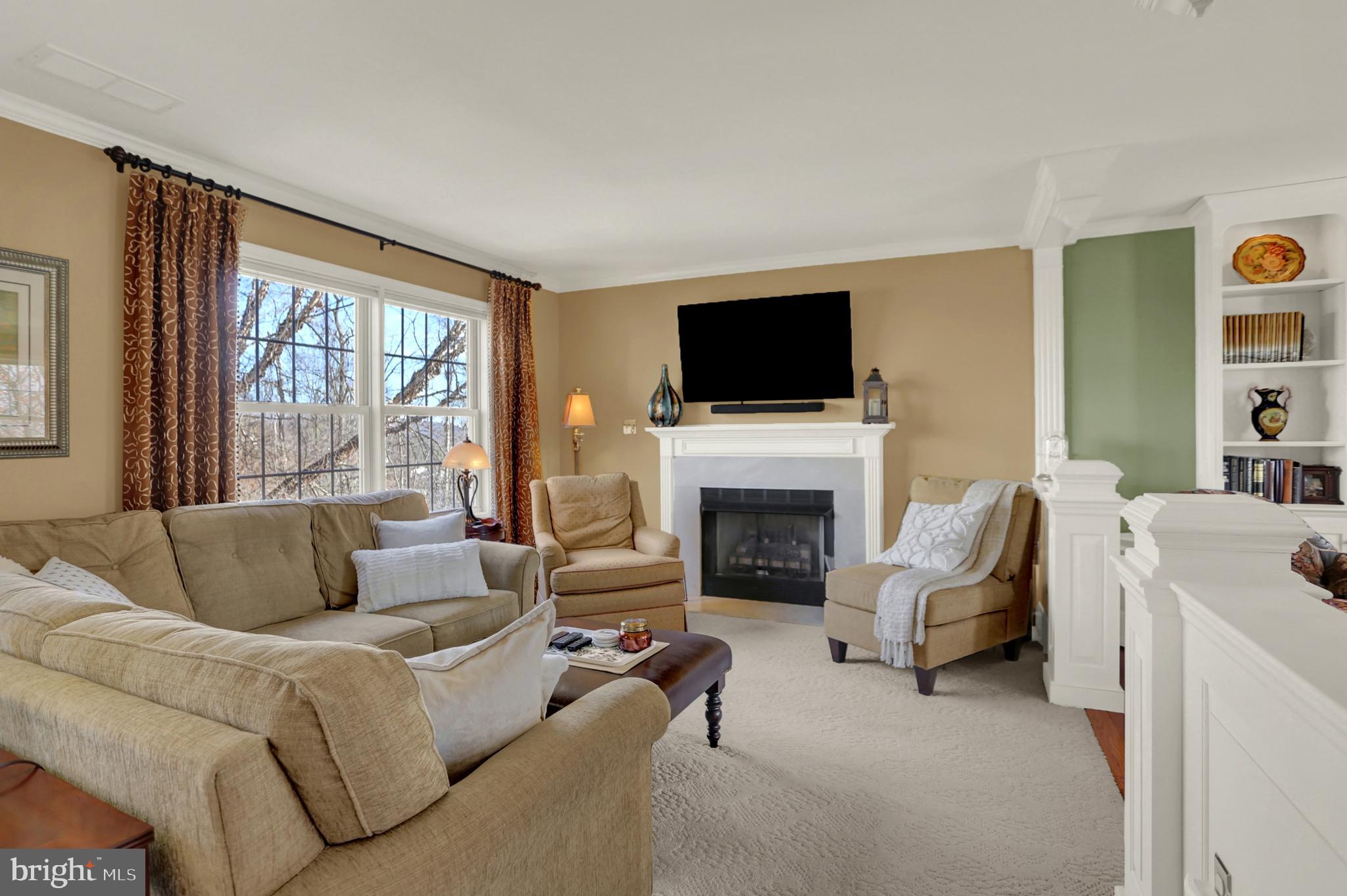 402 Hidden Valley Road New Cumberland, PA 17070 - Photo 9 of 50 a living room with furniture a fireplace and a flat screen tv