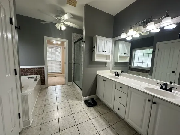a bathroom with a double vanity sink and a mirror