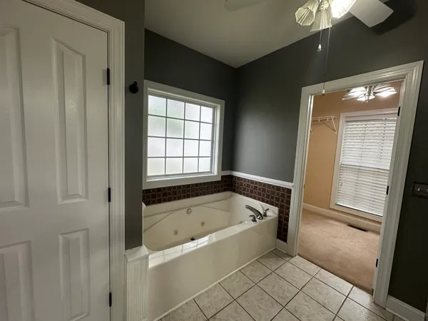a spacious bathroom with a bathtub and shower