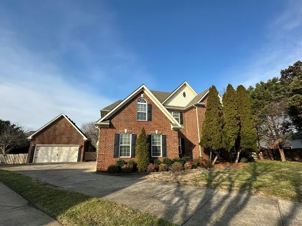 a view of a house with a yard and garage