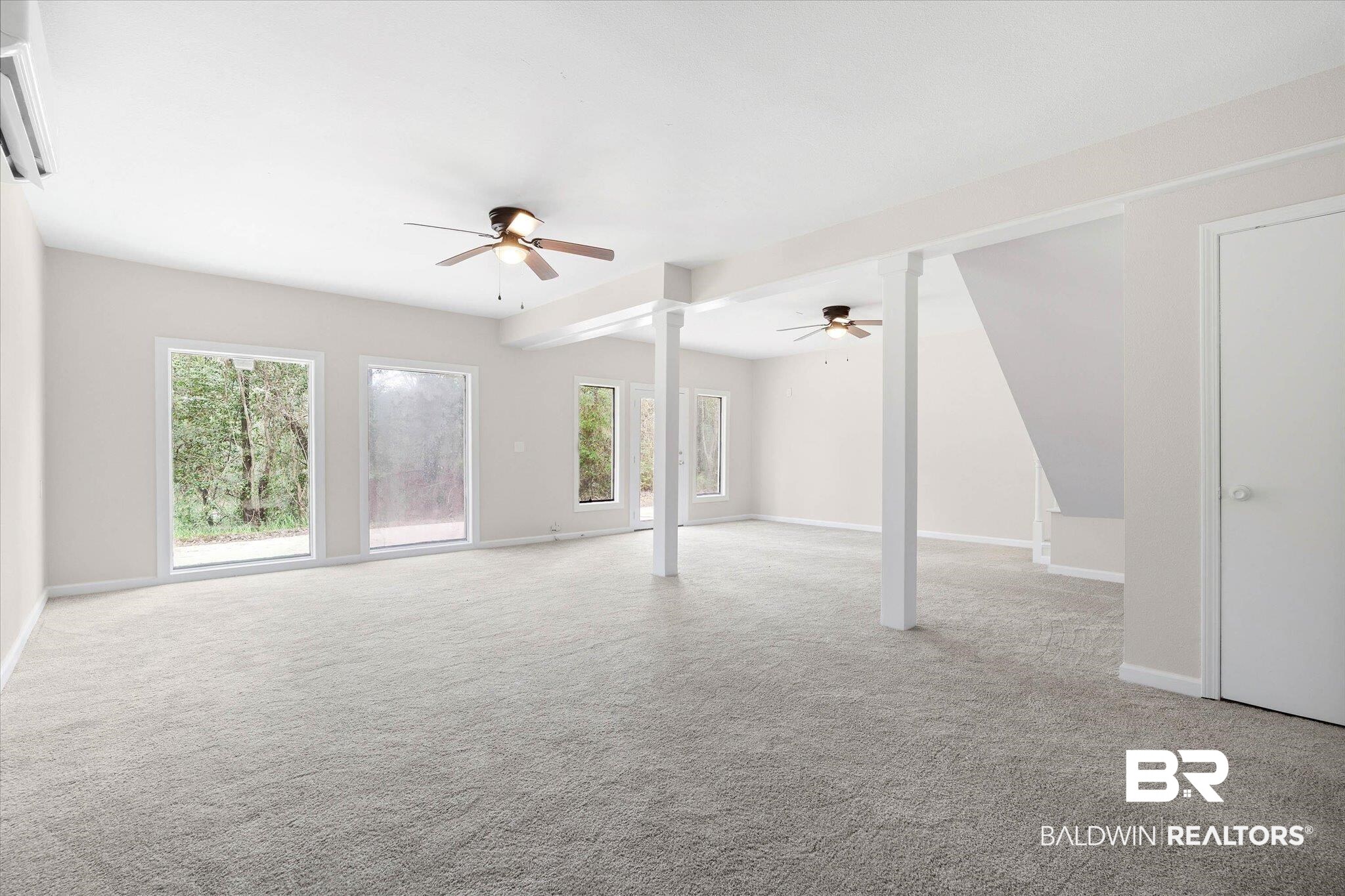 106 Melanie Loop Daphne, AL 36526 - Photo 20 of 45 Unfurnished living room with healthy amount of natural light, light colored carpet, and ceiling fan