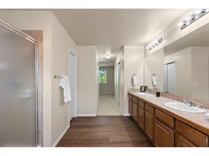 a bathroom with a double vanity sink and mirror