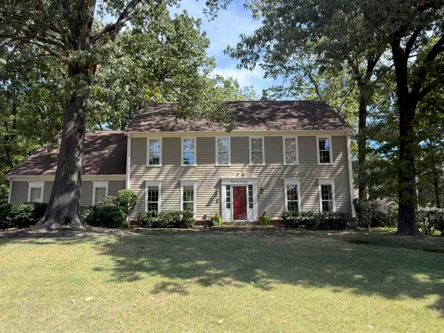 a front view of a house with a yard table and chairs
