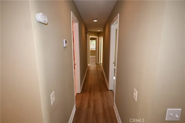 a view of hallway with wooden floor