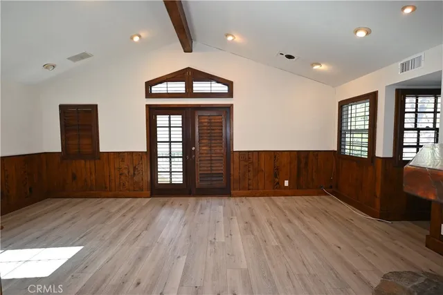 a view of wooden floor and windows in an empty room