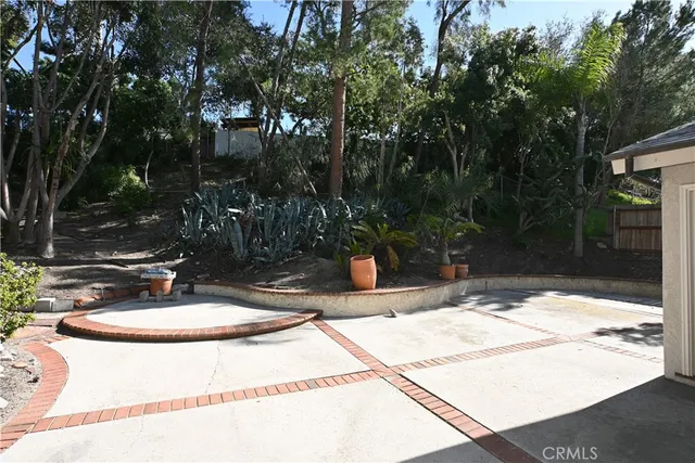 a view of a house with a yard and tree s