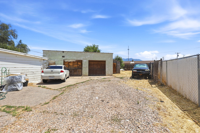 5480 South 2000th Street West Roy, UT 84067 - Photo 28 of 36 Detached two-car garage with wood doors and concrete driveway