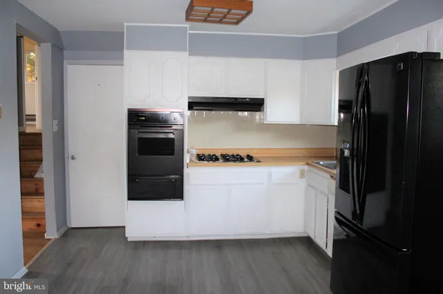 a kitchen with a refrigerator and a stove