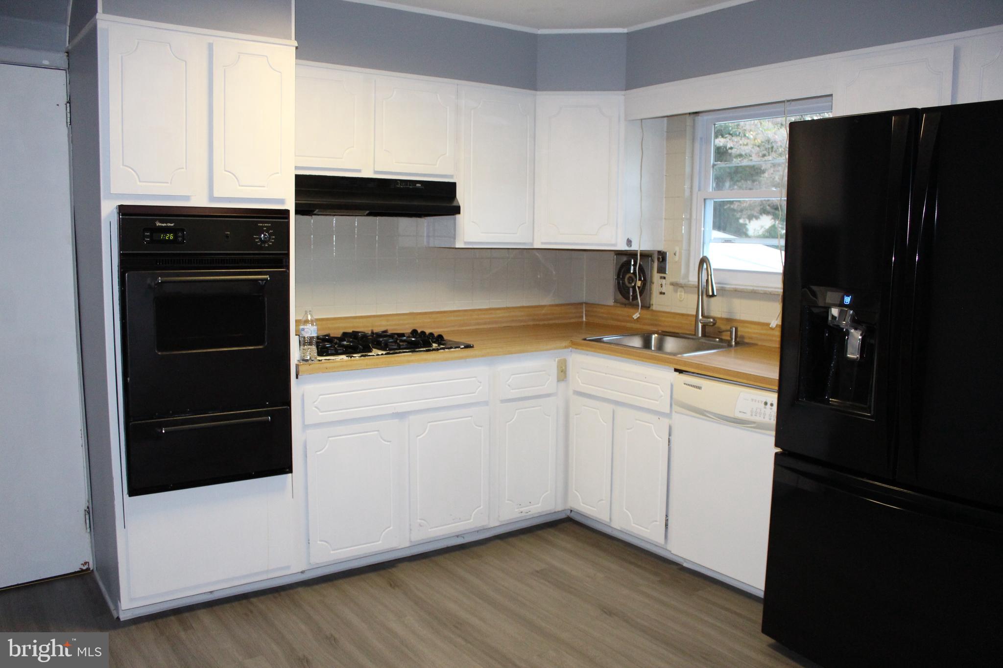 413 Dickinson Road Glassboro, NJ 08028 - Photo 9 of 16 a kitchen with a refrigerator and a stove