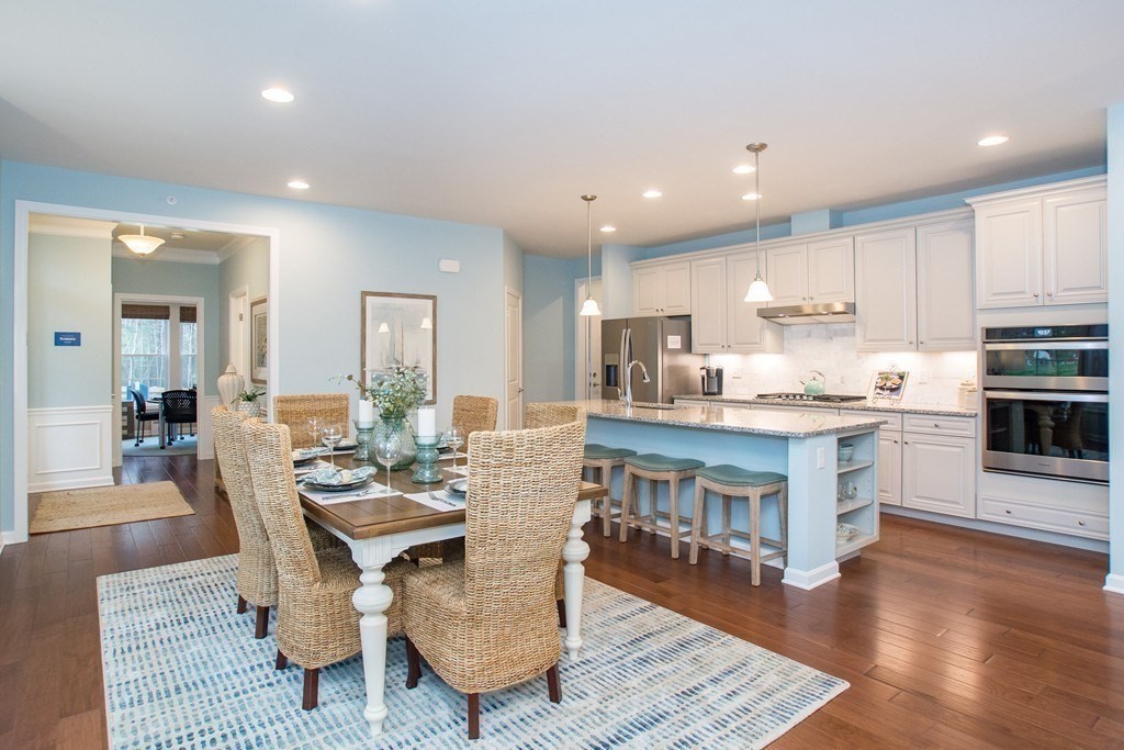 40 Sienna Circle, Unit 53 Upton, MA 01568 - Photo 2 of 10 a living room with stainless steel appliances furniture and a kitchen view
