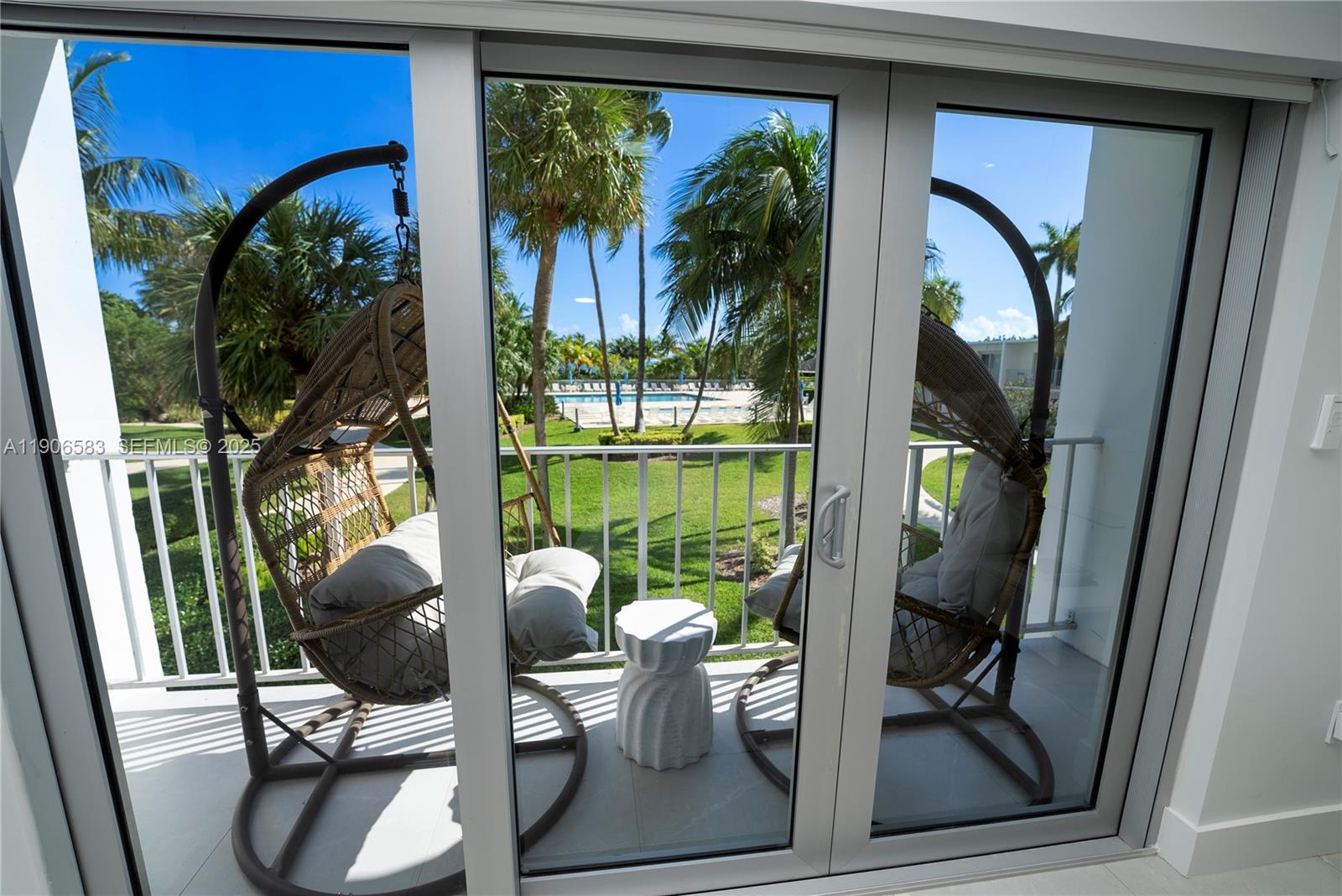 881 Ocean Drive, Unit TH15 Key Biscayne, FL 33149 - Photo 5 of 26 a view of a porch with chairs and potted plants