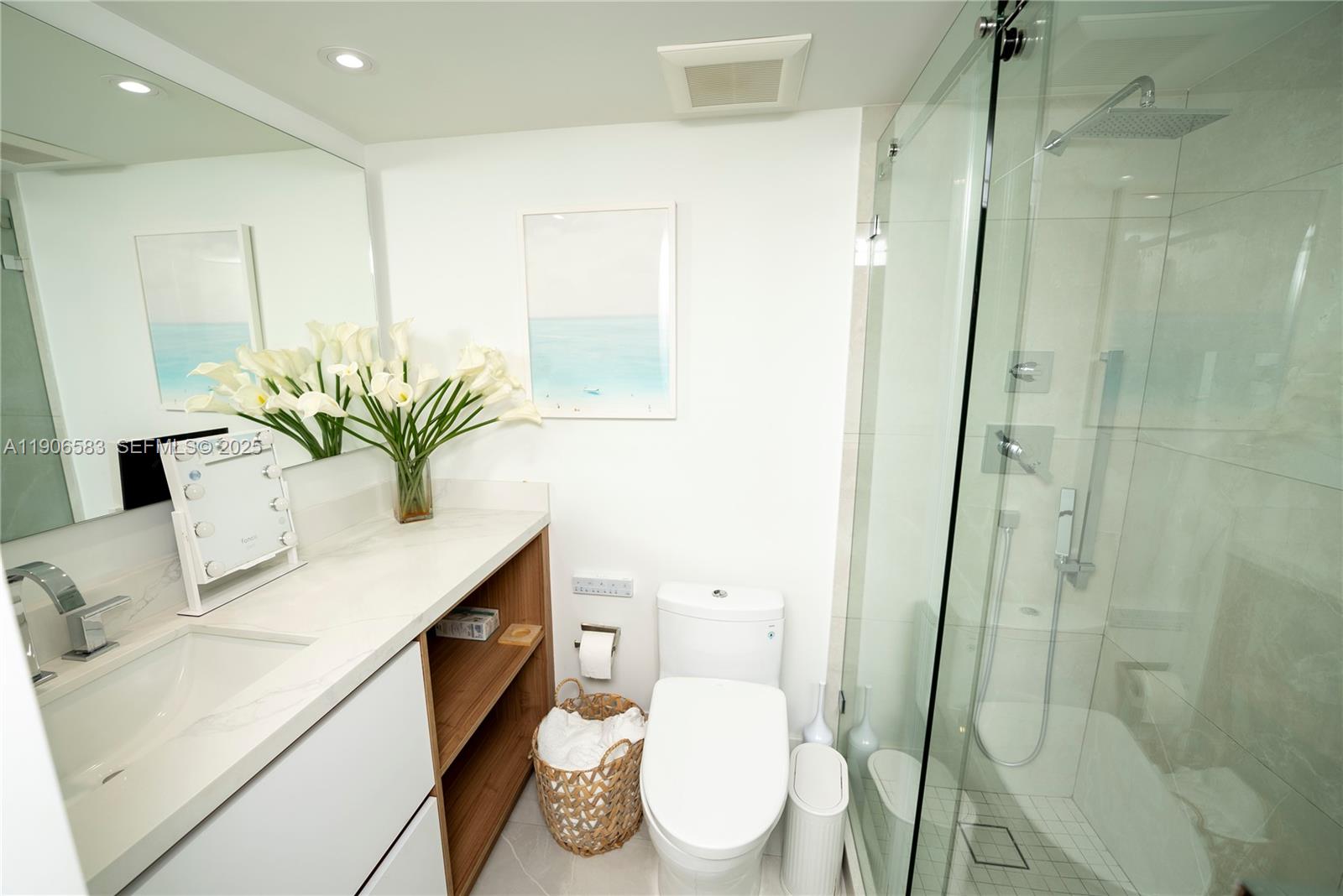 881 Ocean Drive, Unit TH15 Key Biscayne, FL 33149 - Photo 9 of 26 a bathroom with a sink a mirror a toilet and shower