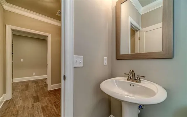 an empty room with windows fireplace and wooden floor