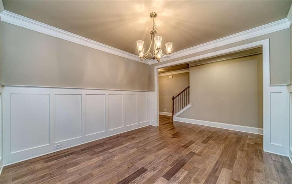 514 Adventure Trail Jefferson, GA 30549 - Photo 14 of 49 a view of a room with wooden floor staircase and a kitchen space