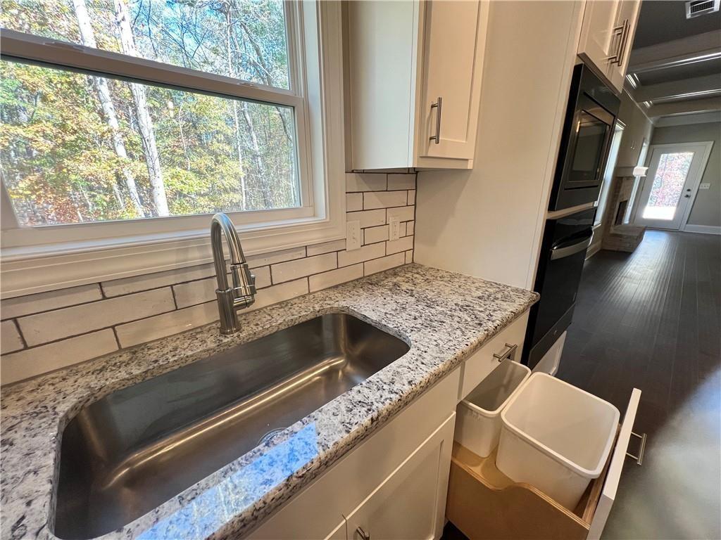 514 Adventure Trail Jefferson, GA 30549 - Photo 19 of 48 a kitchen with granite countertop a sink and a stove