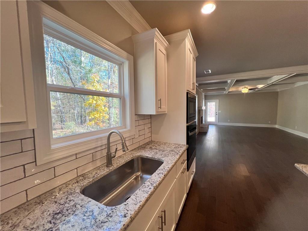 514 Adventure Trail Jefferson, GA 30549 - Photo 23 of 49 a kitchen with a sink a counter top space and stainless steel appliances
